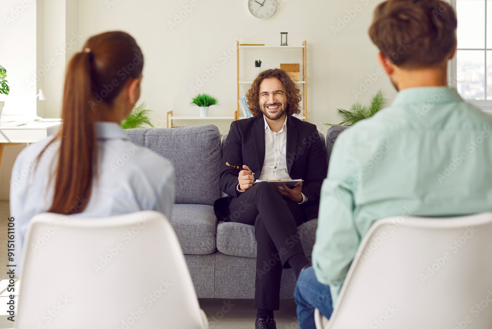 Obraz premium Young couple sitting back on chairs and listening to psychologist advice trying to find problems and solution at counselor's office. Family therapy, relationship and mental health concept.