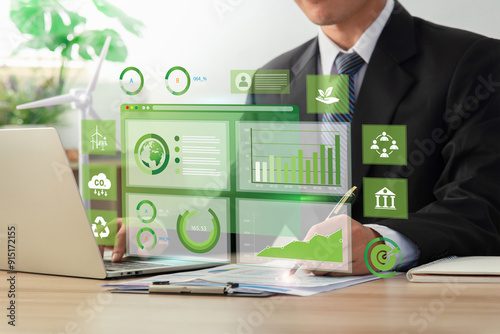 Businessman analyze sustainability investment with icons and Green chart. Concept of ESG, Green businesses, Net zero, Green energy, Carbon neutral, Green technology, and Carbon credit. CSR. photo