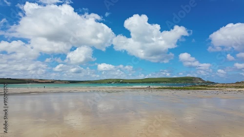 Pan, right to left from Daymers Bay, Beach with reflection of clouds in wet sand at low tide photo