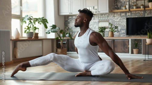 A man is doing yoga in a living room