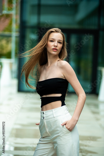  beautiful stylish fashion woman posing near modern building