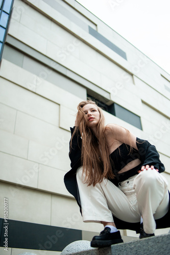 beautiful stylish fashion woman posing near modern building