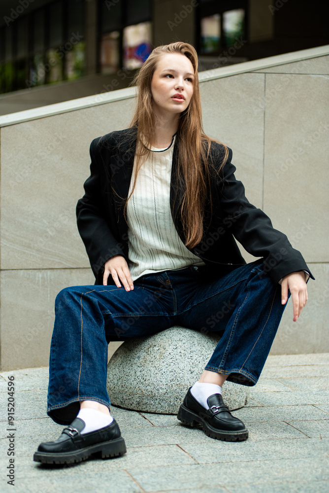 Young woman with long hair black jacket and white trousers street style Young woman with long hair black jacket and white trousers street style