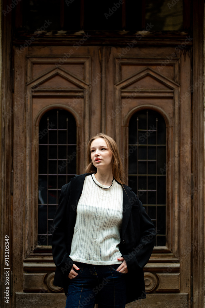 young beautiful woman posing on the street formal modern clothes. beautiful fashionable girl posing in the street young beautiful woman posing on the street formal modern clothes. beautiful fashionable girl posing in the street