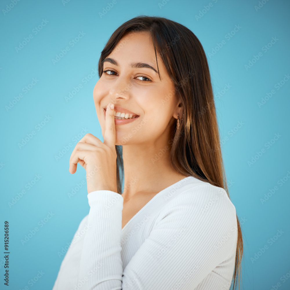 Hush, portrait and smile with woman in studio isolated on blue background for gossip, mystery or secret. Emoji, privacy or voice of happy person with finger on lips for confidential, silence or quiet Hush, portrait and smile with woman in studio isolated on blue background for gossip, mystery or secret. Emoji, privacy or voice of happy person with finger on lips for confidential, silence or quiet
