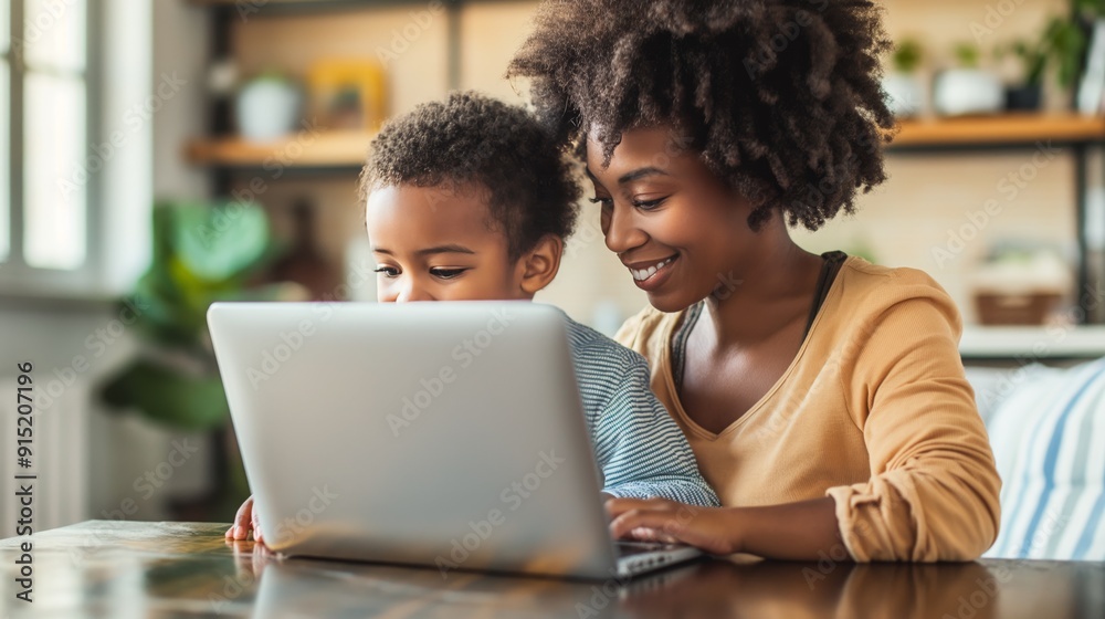 Smiling Mother and Child Using Laptop Together in Bright, Modern Home Environment Smiling Mother and Child Using Laptop Together in Bright, Modern Home Environment