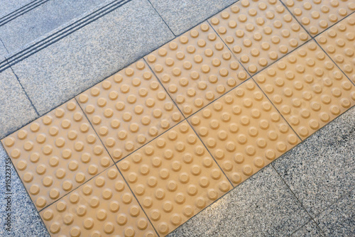 warning block, tactile, braille block, guiding block for safety of the blind, blind guidance block for visually impaired people at stairs of public walkway photo