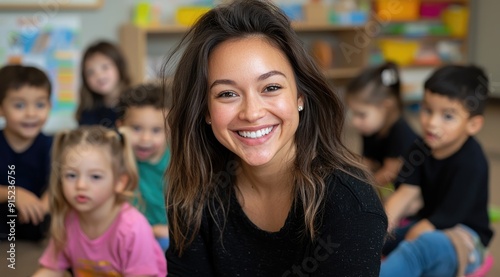 Smiling Hispanic Teacher Engaging with Multicultural Preschool Children in Classroom