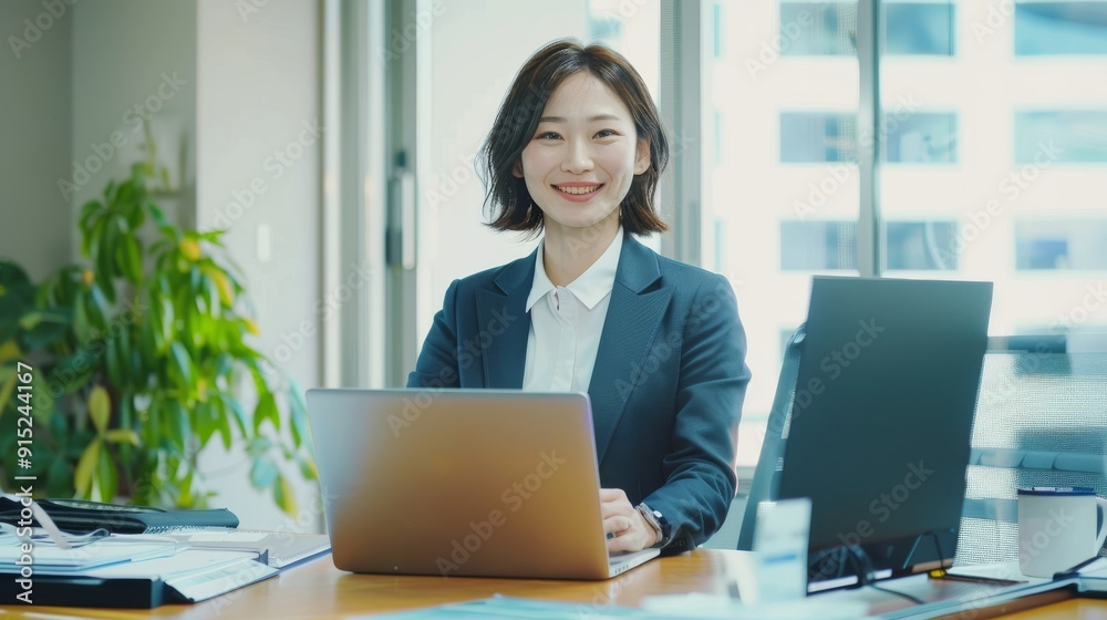 A professional woman sits confidently in her modern office, working on a laptop, radiating focus and determination in a bright environment. A professional woman sits confidently in her modern office, working on a laptop, radiating focus and determination in a bright environment.
