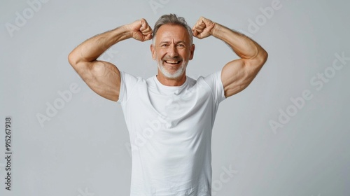 A man with a big smile on his face is flexing his muscles