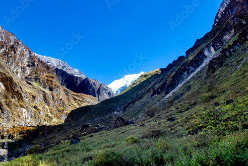 Beautiful mountain scenery. River, valley, snow, blue sky, white clouds. In-depth trip on the Sonamarg Hill Trek in Jammu and Kashmir, India