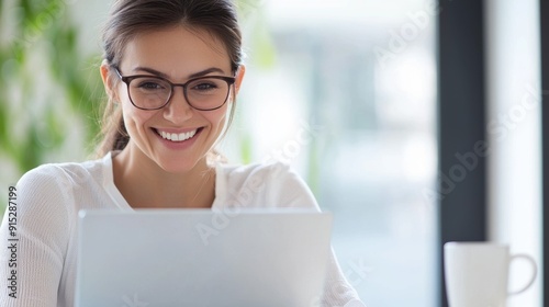 a woman sitting at a table with a laptop