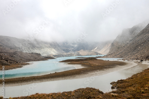 Beautiful mountain scenery. River, valley, snow, blue sky, white clouds. In-depth trip on the Sonamarg Hill Trek in Jammu and Kashmir, India photo