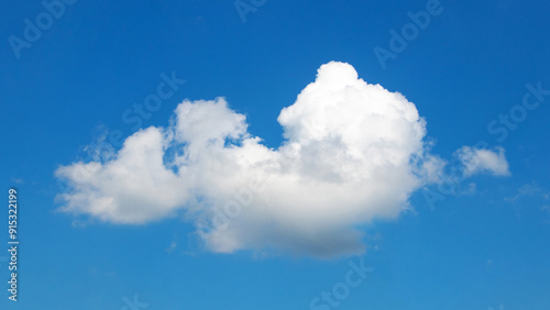 White soft curly cloud in blue sky