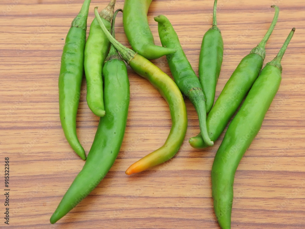 green chili peppers on wooden background, copy space, selective focus green chili peppers on wooden background, copy space, selective focus