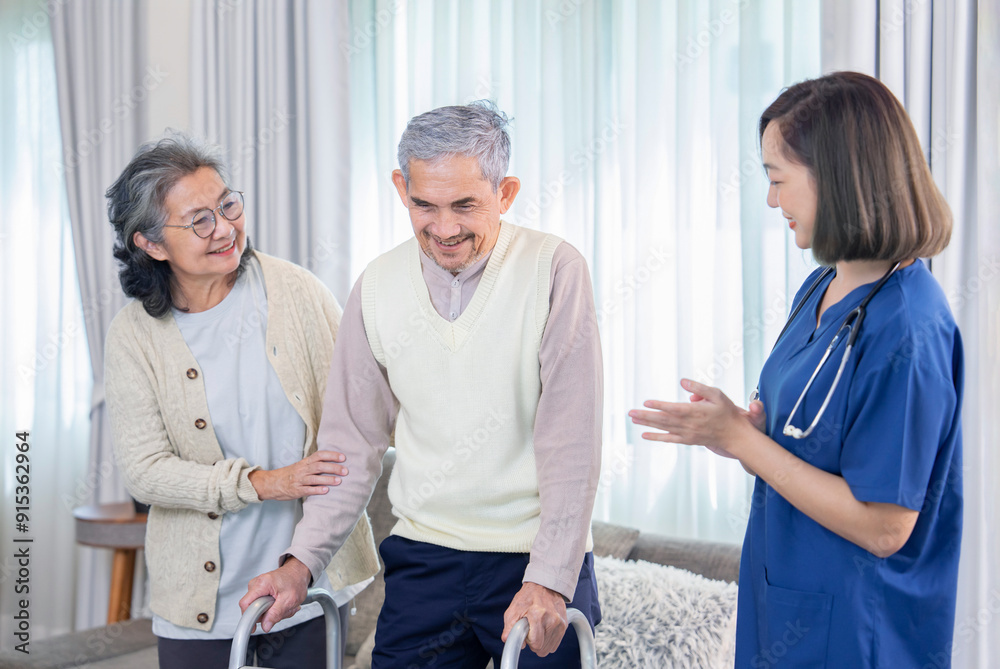 Fototapeta premium old asian man patient trying to walk by using walker,being assist by a nurse caregiver and a senior wife standing and supporting beside him,concept of elderly health care,homecare,home health nursing