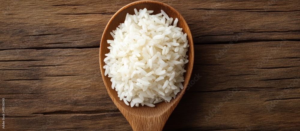 jasmine rice on a wooden spoon with copyspace jasmine rice on a wooden spoon with copyspace