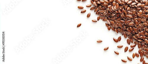 Flax seeds on sipano at the edge of the frame against a white background with copyspace photo