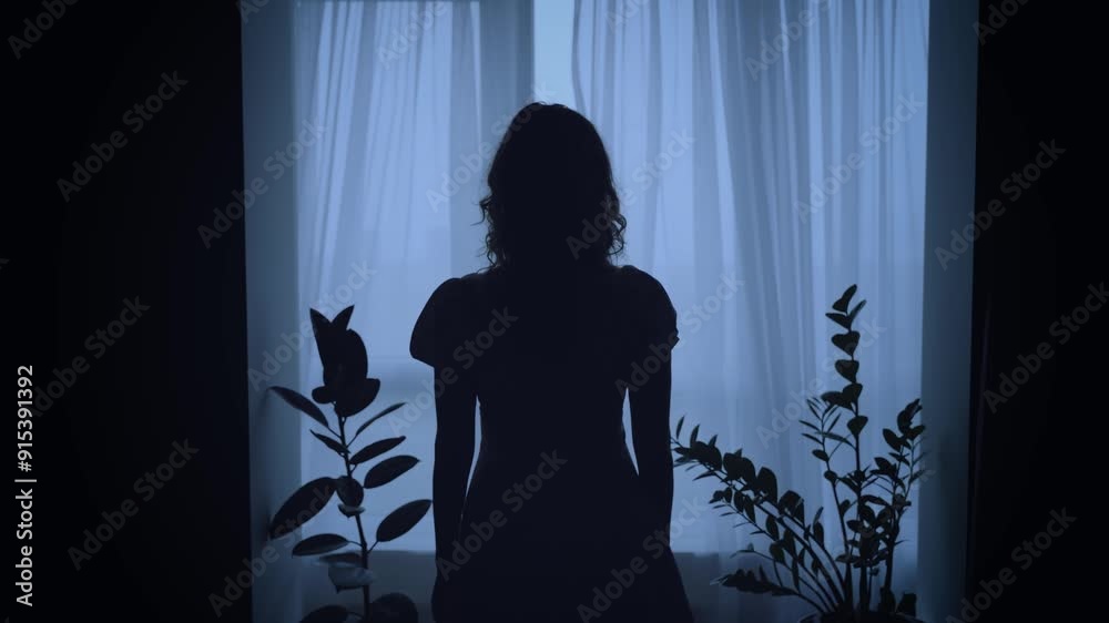 unrecognizable black dark silhouette of woman standing looking at window, mood depression sadness loneliness emotion. Mystery Adult Girl back rear view. wind blows curtains fly waving white fabric 4k