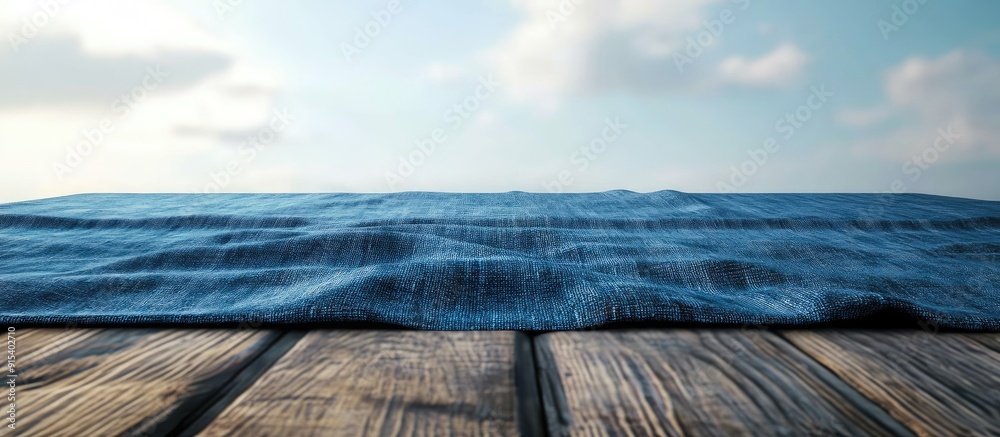 Blue tablecloth laid over a wooden table. with copy space image. Place for adding text or design Blue tablecloth laid over a wooden table. with copy space image. Place for adding text or design