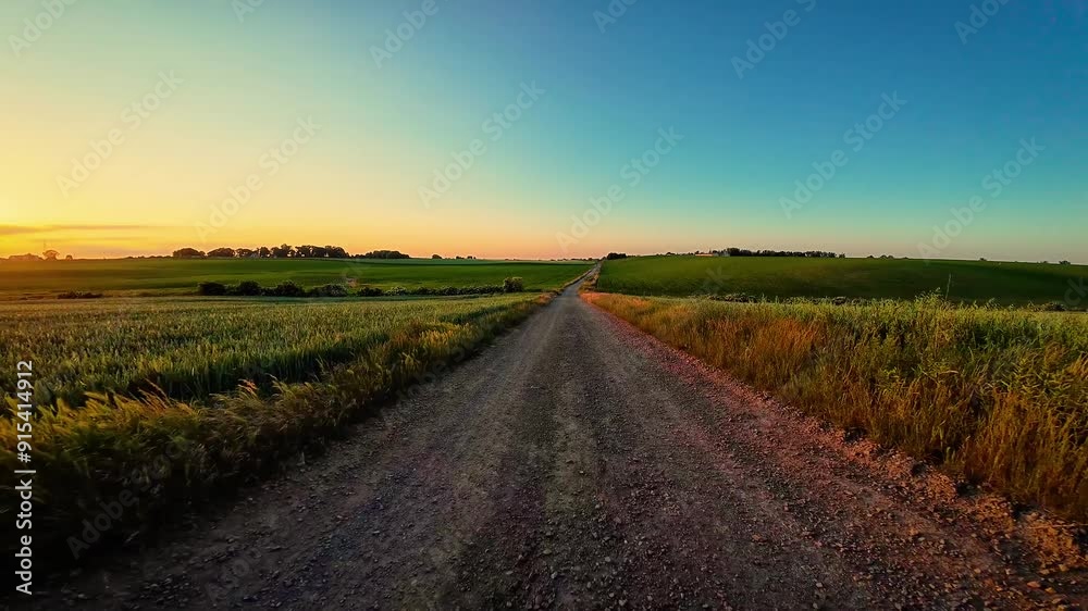 Car driving along rural road during sunset. Driver POV view of road and adventures, Active leisure, trips, adventures, relaxation Car driving along rural road during sunset. Driver POV view of road and adventures, Active leisure, trips, adventures, relaxation