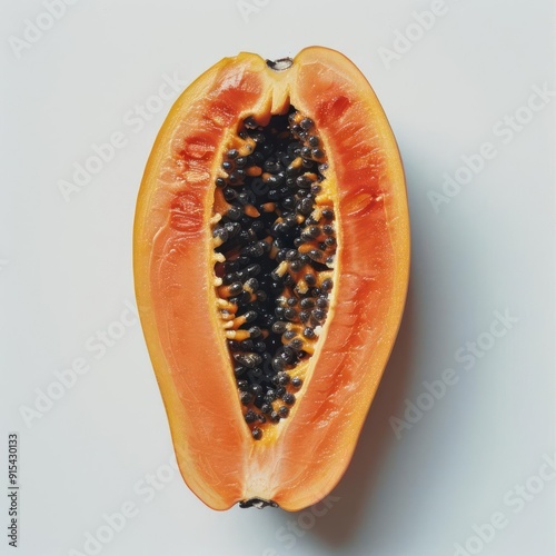 A close-up of a half cut open pitaya or dragon fruit. The seeds are exposed, photo