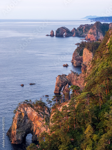 The scenery of Kitayamazaki Cliffs at the sunrise on the Michinoku Coastal Trail, the northern part of Sanriku Fukko National Park, Iwate prefecture, Tohoku, Japan photo