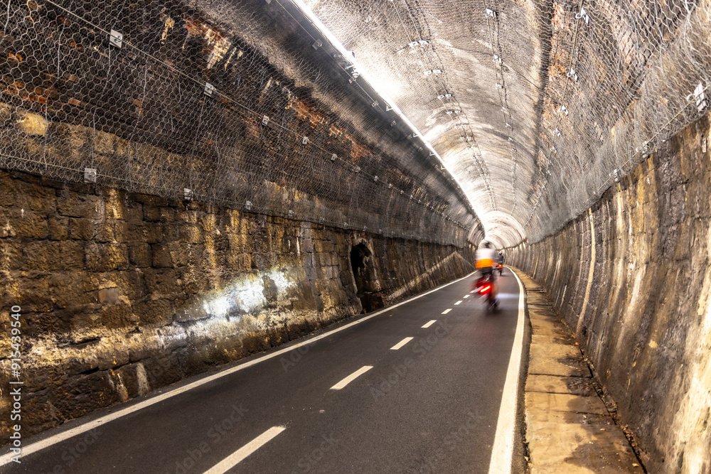 Biking through tunnel on the alpe adria cycle route ( Pontebanna ) through the Val Canale in Italy