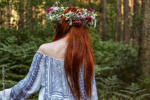 Girl in the forest, in a wreath of flowers. Beautiful forest at sunset. Girl in ethnic clothes