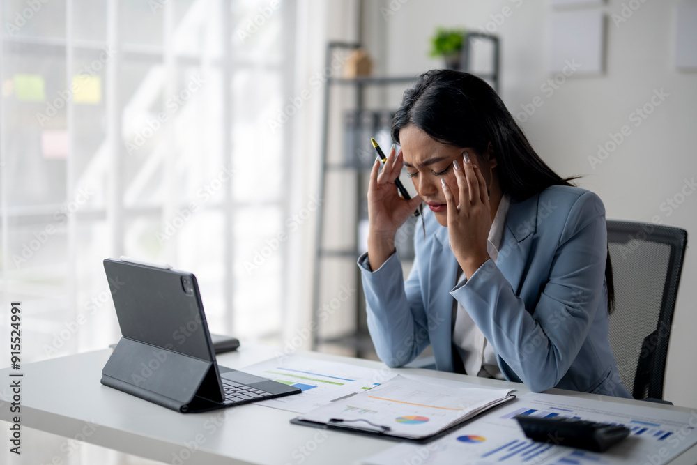 A woman in a blue suit is on the phone, looking very stressed A woman in a blue suit is on the phone, looking very stressed
