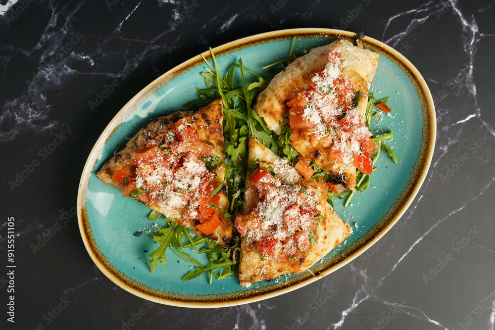 Slices of bruschetta with tomato, salad and parmesan cheese Slices of bruschetta with tomato, salad and parmesan cheese