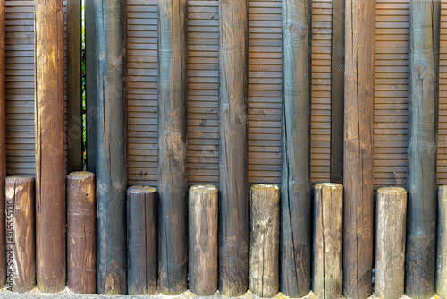 row of wooden posts with some of them being black and some brown