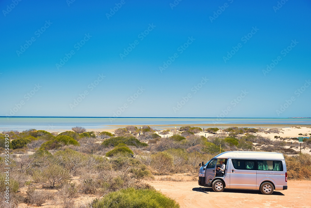 Small campervan with elderly woman in the dunes close to Denham, Western Australia. In the distance the tropical waters of Shark Bay, Coral Coast
Small campervan with elderly woman in the dunes close to Denham, Western Australia. In the distance the tropical waters of Shark Bay, Coral Coast