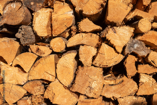 Pile of dry chopped firewood prepared for winter. Natural background.