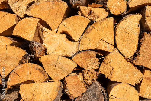 Pile of dry chopped firewood prepared for winter. Natural background.