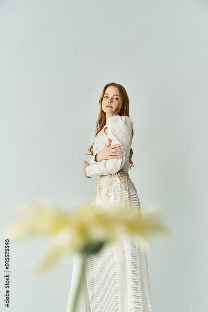 A young woman holds flowers, embodying grace and beauty in a soft, bright atmosphere. A young woman holds flowers, embodying grace and beauty in a soft, bright atmosphere.