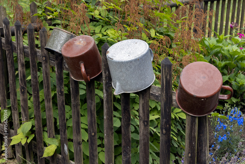 Enamel pots at wooden gate. Ostritz. Saxonia. Germany. east Germany. photo