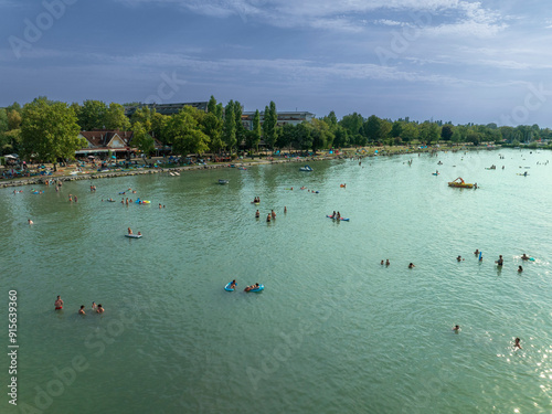 Beach in Lake Balaton. People bathing in the water of lake in  hot summertime. There are many popular summer resorts around the lake Balaton in Hungary. photo