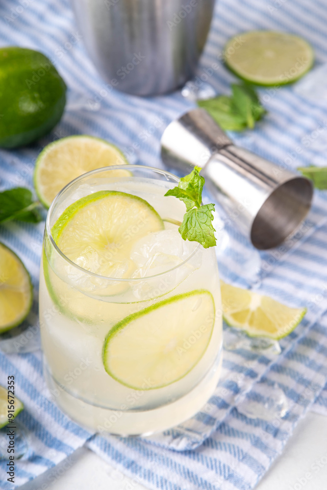 Summer cold refreshment limeade cocktail, cold alcohol or non-alcohol beverage with limes, mint and ice cubes, copy space Summer cold refreshment limeade cocktail, cold alcohol or non-alcohol beverage with limes, mint and ice cubes, copy space