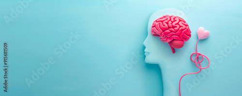 Top view of human head with brain made from red heart and pink rubber tube on blue background, mental health concept, copy space banner for ve, minimal flat lay style