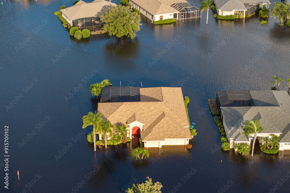 Naklejka premium Flooded residential area with underwater houses and cars from hurricane Debby rainfall water in Laurel Meadows community in Sarasota, Florida. Aftermath of natural disaster in southern USA