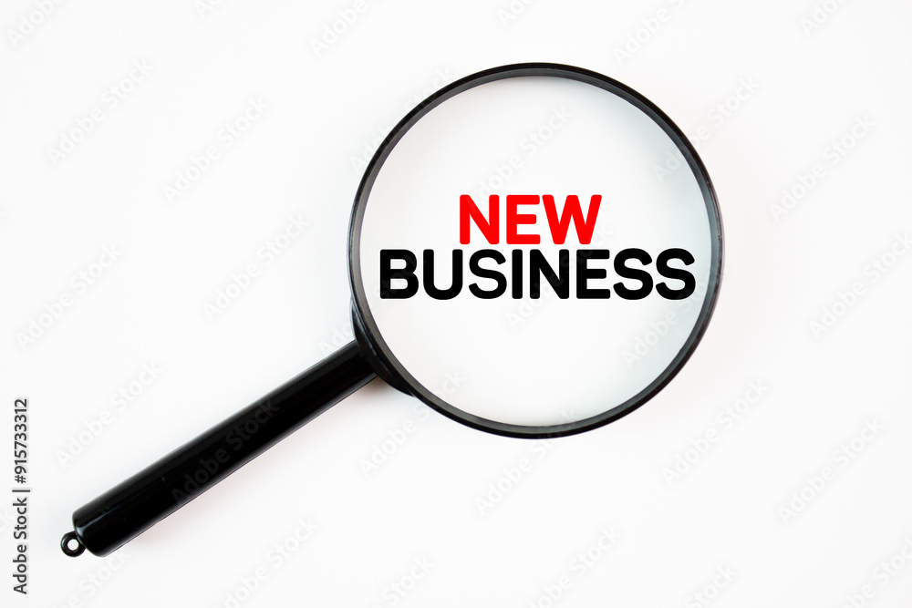 NEW BUSINESS text,word inscription through a magnifying glass on a white background. New business, startup business project, market research, trends, concept, wallpaper. NEW BUSINESS text,word inscription through a magnifying glass on a white background. New business, startup business project, market research, trends, concept, wallpaper.
