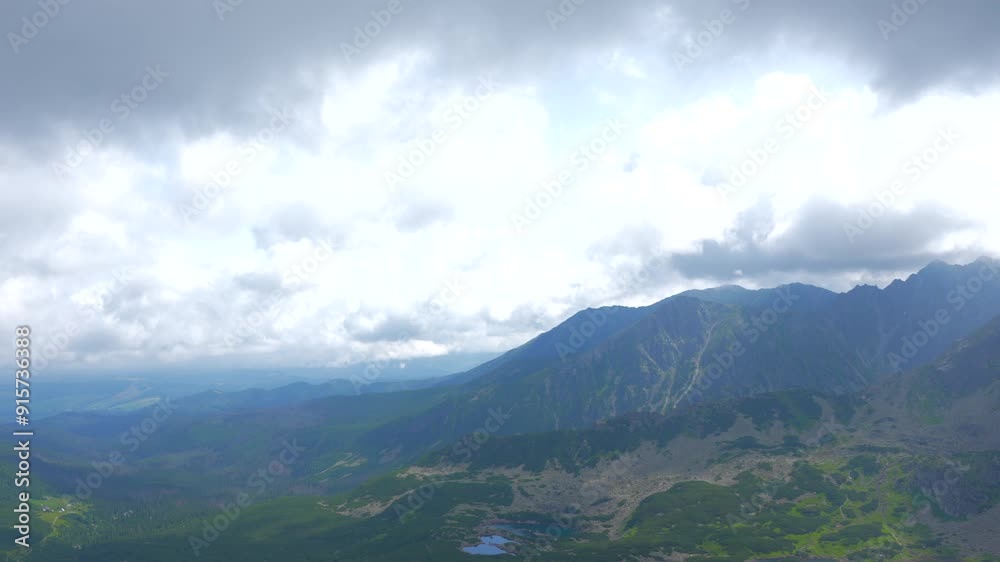 Girl on the top with phone. Zakopane, Panoramic view in the fog of clouds Girl on the top with phone. Zakopane, Panoramic view in the fog of clouds