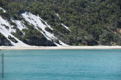 Sailing on the crystal clear turqoise blue water around the white sand beaches of Fraser Island in Queensland, Australia photo