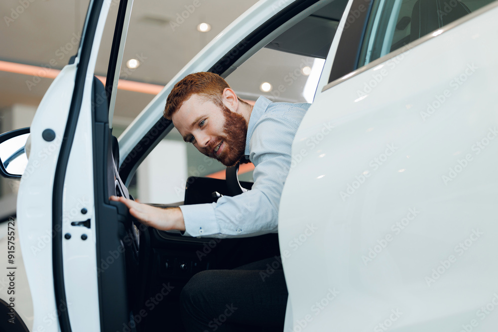 Handsome bearded man customer client in suit get out car, touch door. Concept sales automobile in showroom vehicle store Handsome bearded man customer client in suit get out car, touch door. Concept sales automobile in showroom vehicle store