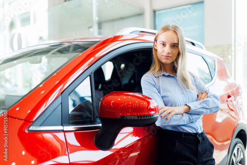 Lifestyle portrait woman driving with smile, confidently hand on steering wheel, joyful moment of buy first car independence in showroom photo