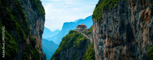 A mountain pass with a narrow path, sheer cliffs on either side, and an ancient temple perched at the top