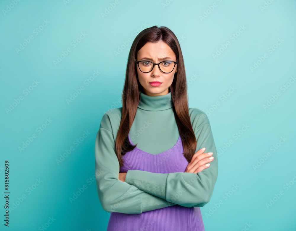 studio shot young woman with glasses crossed arms worried look on plain background studio shot young woman with glasses crossed arms worried look on plain background