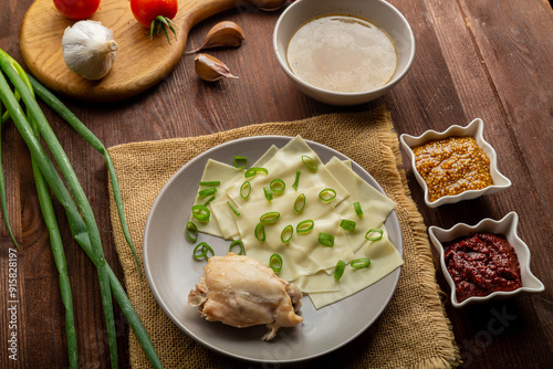 Dagestan khinkal thin dough, meat, meat broth, with mustard and adjika on the table