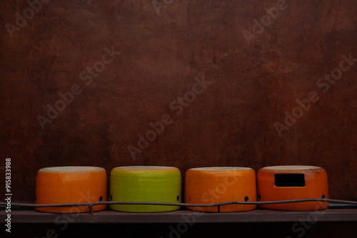 A ceramic pot sits upside down in front of an orange brick wall
